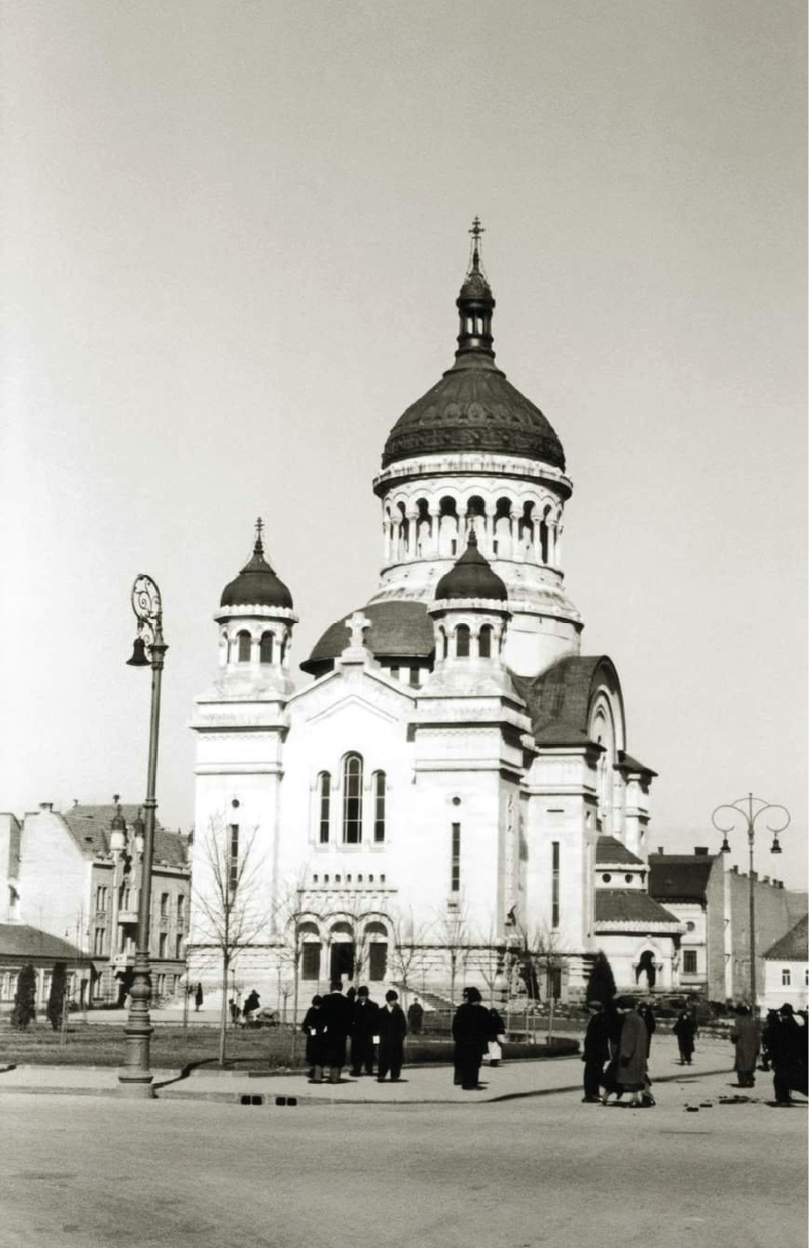 An archival photograph of the Cluj cathedral fading over the same view today
