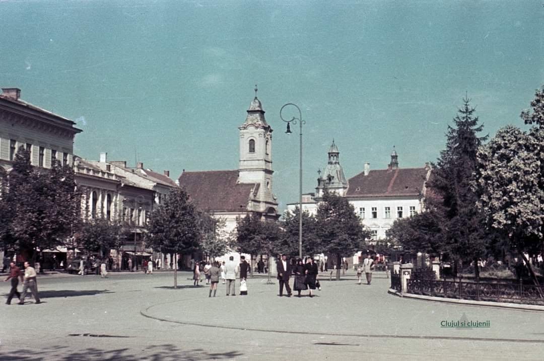 A wide archival view of a Cluj square, panning slowly from side to side